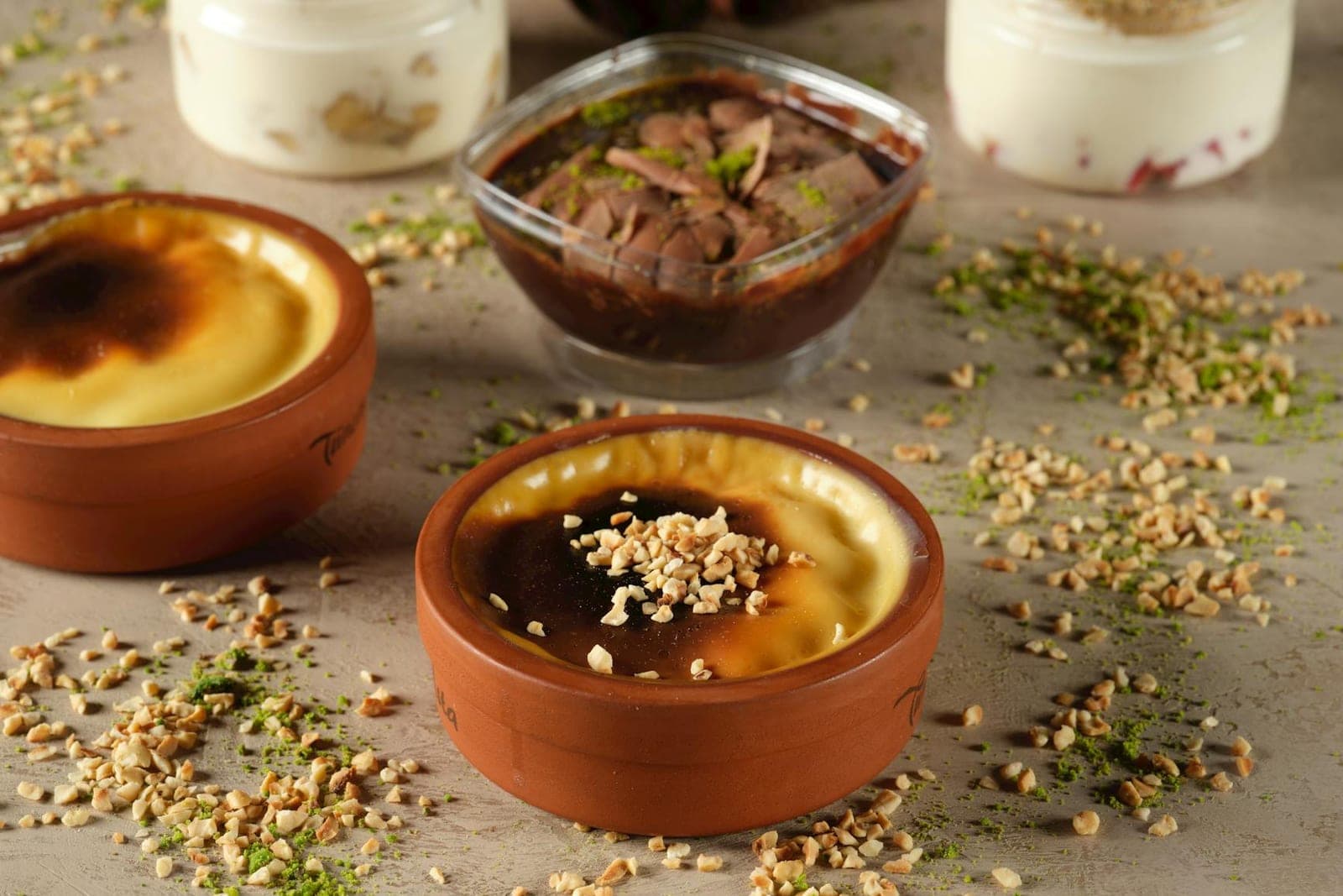 Arroz con leche rice pudding in small bowls with nuts and cinnamon-style topping