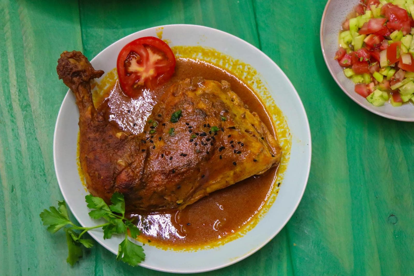 Baked honey mustard chicken thighs with glossy sauce, tomato, herbs, and salad