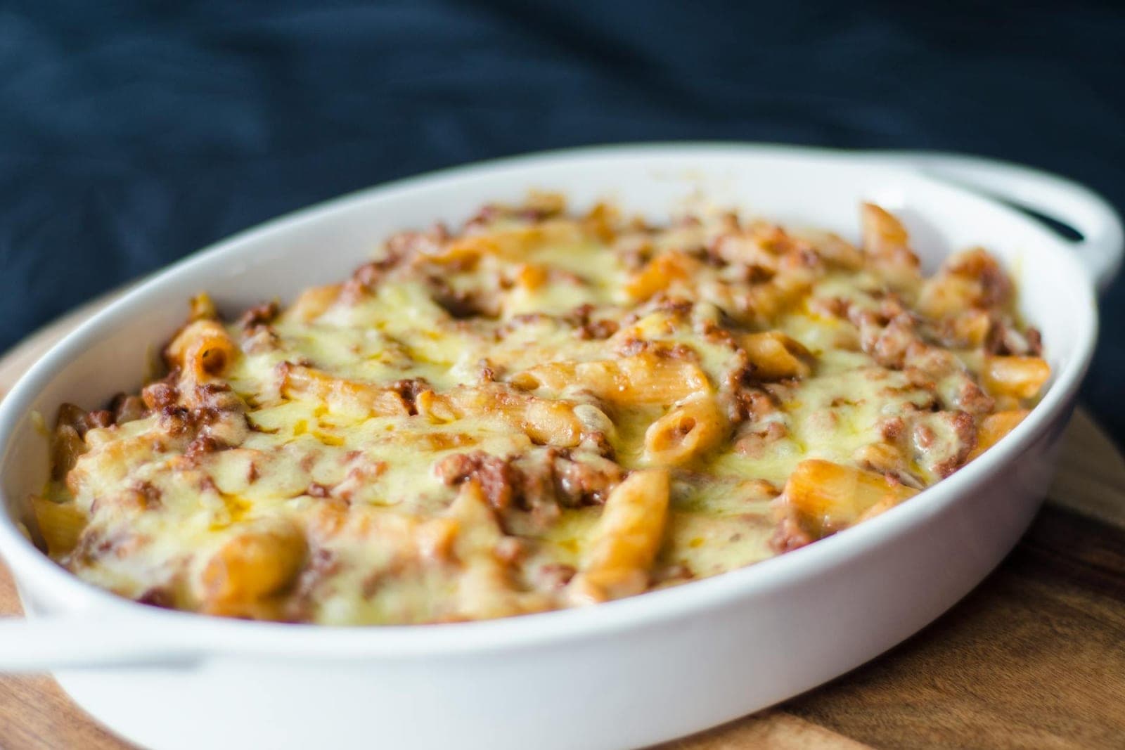 Baked mac and cheese casserole with browned cheese and pasta in a white baking dish