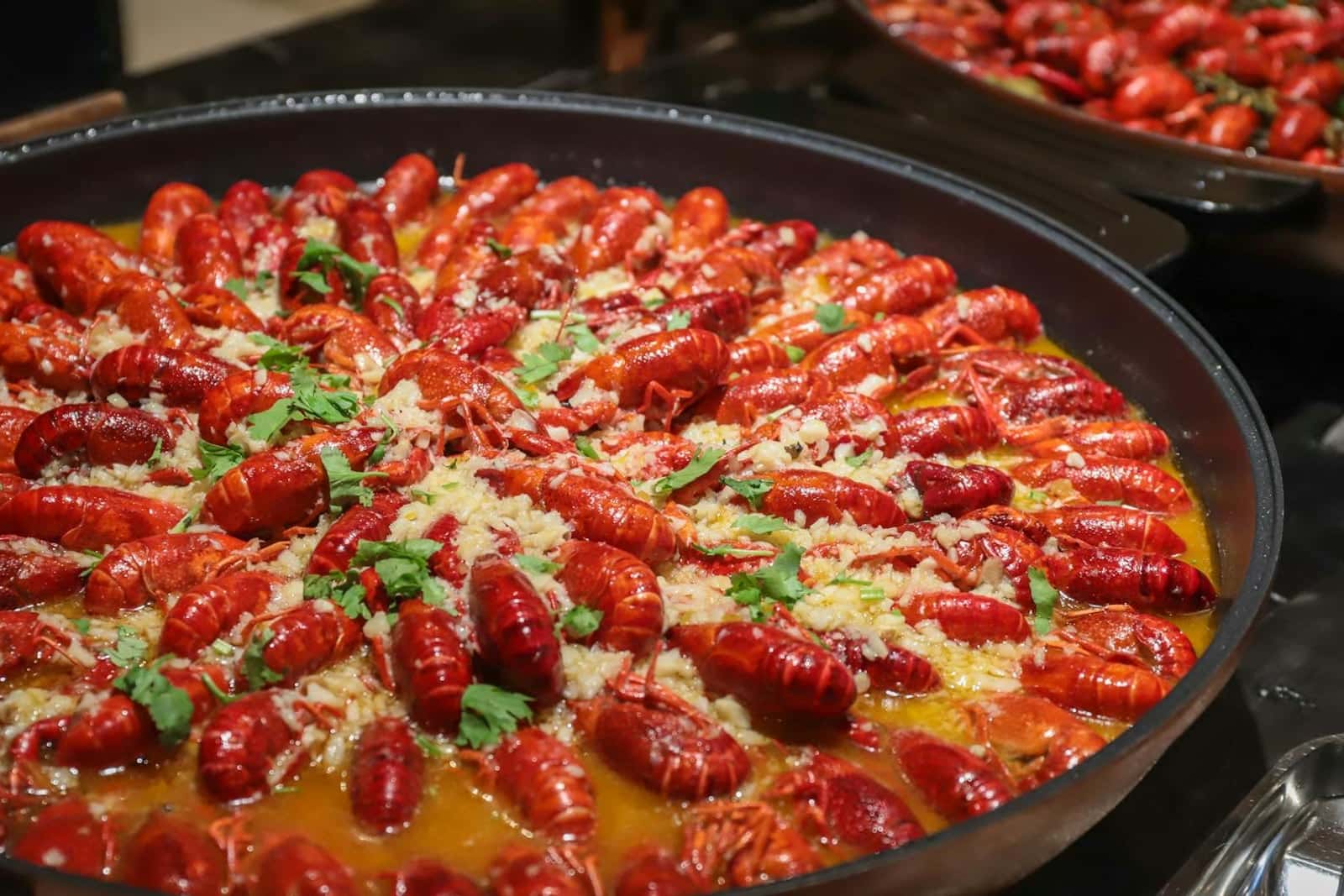 Cajun jambalaya-style rice with crawfish, sausage, herbs, and red spices in a wide pan