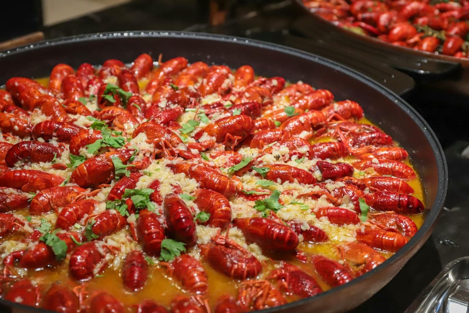 Cajun jambalaya-style rice with crawfish, sausage, herbs, and red spices in a wide pan