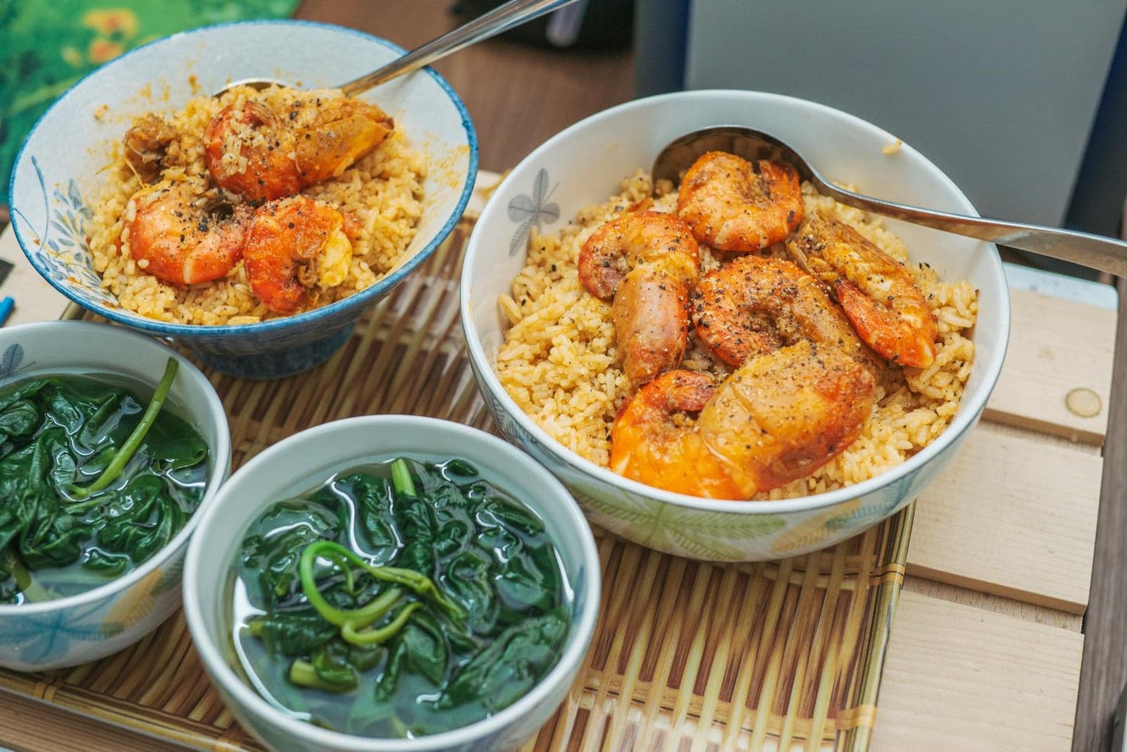 Cajun shrimp rice bowl with seasoned shrimp, grains, and green vegetables