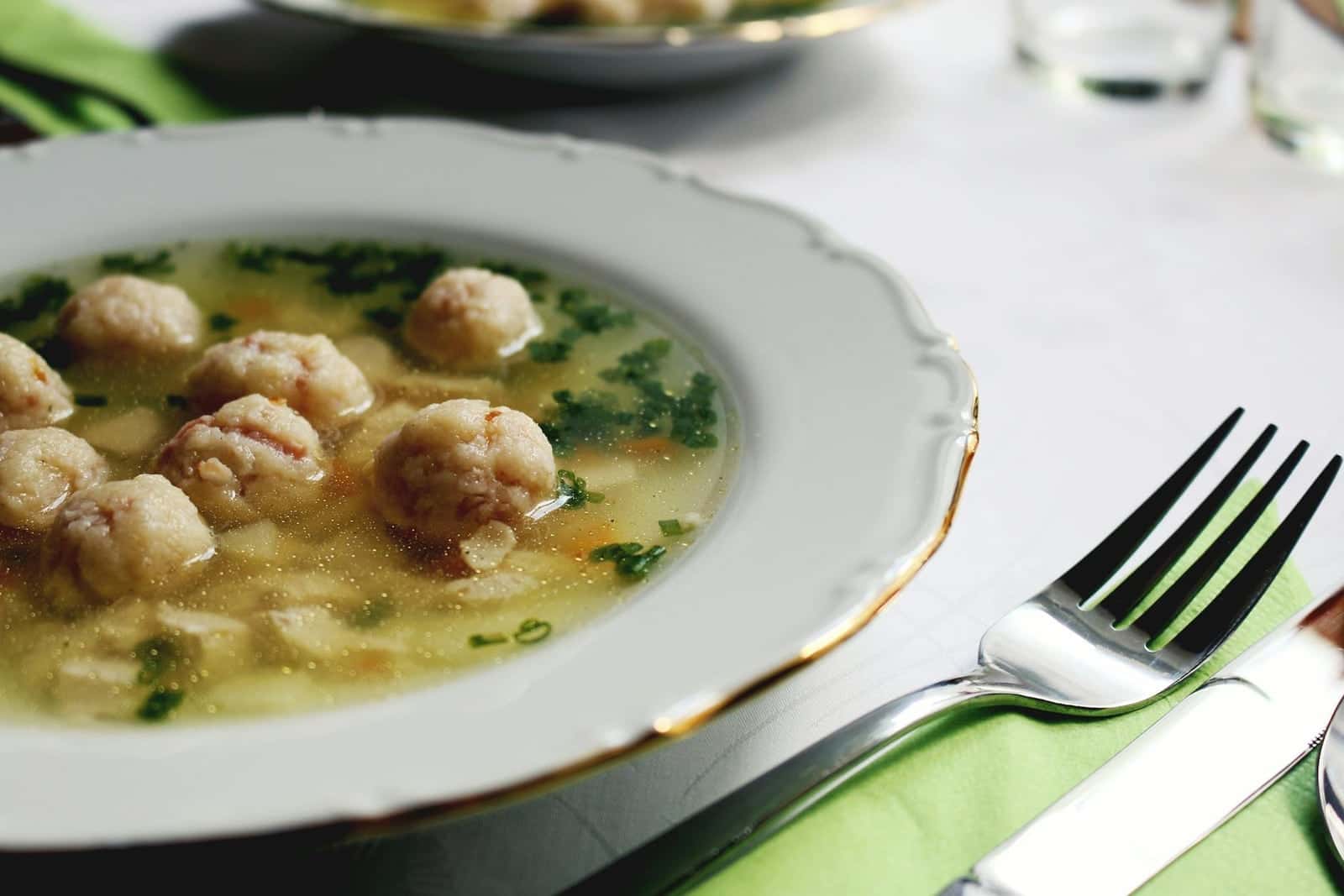 Chicken and dumplings soup with dumplings in a light broth and herbs
