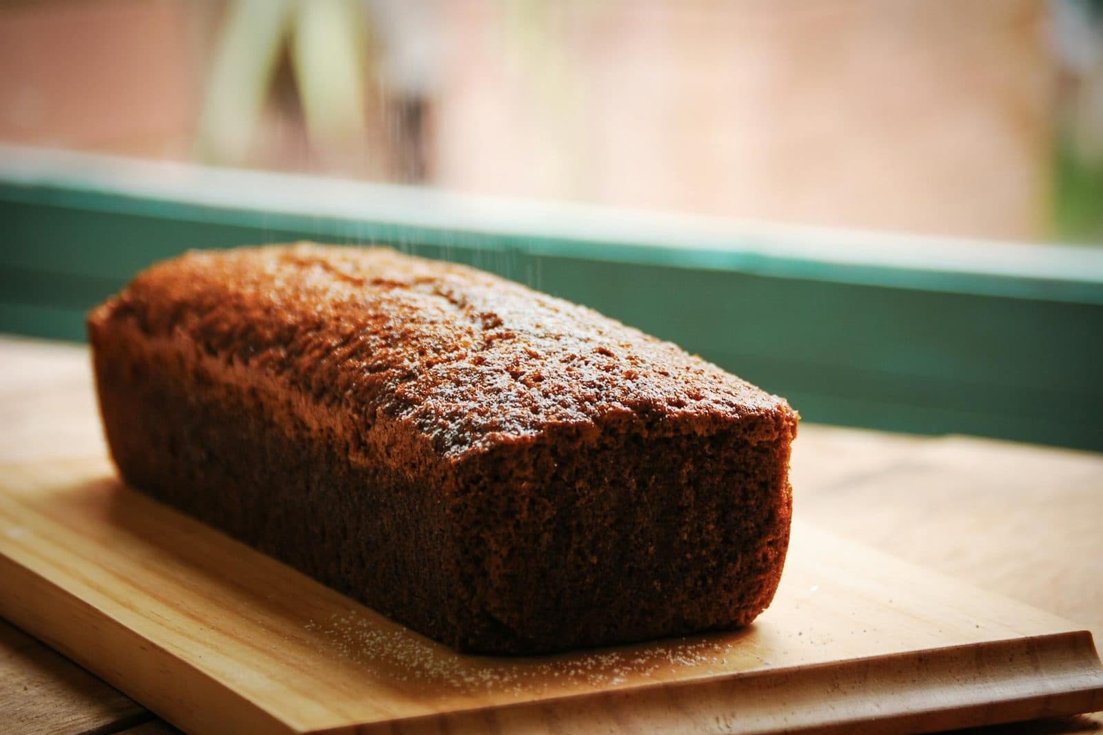 Chocolate tahini swirl banana bread loaf on a wooden cutting board