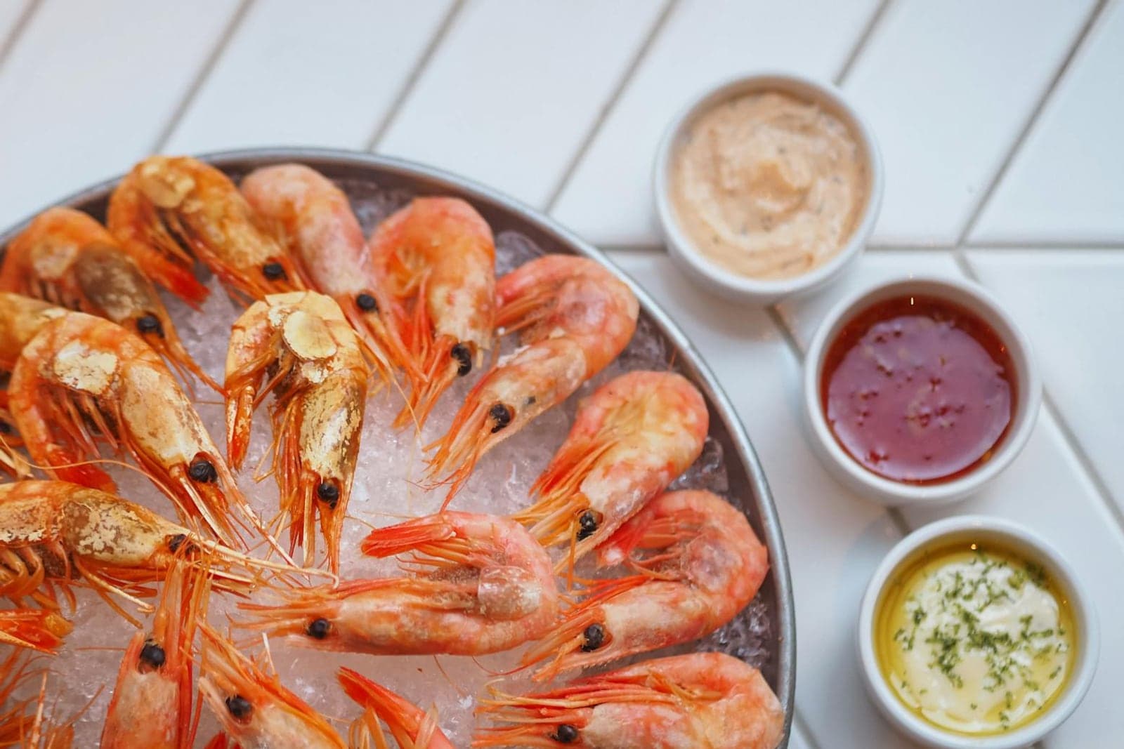 Classic shrimp cocktail-style platter with chilled shrimp and dipping sauces