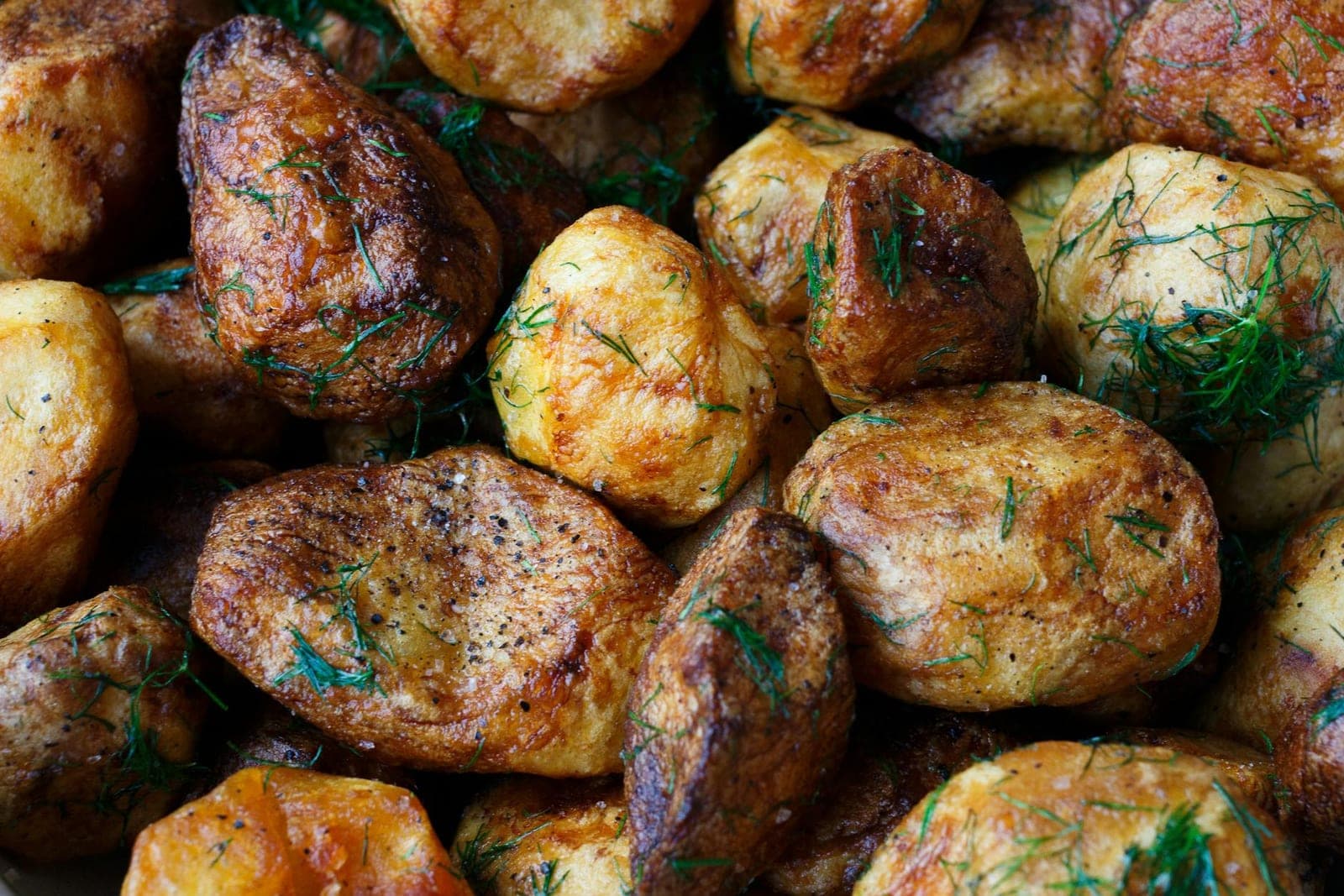 Crispy smashed potatoes with garlic herb butter, dill, and browned edges