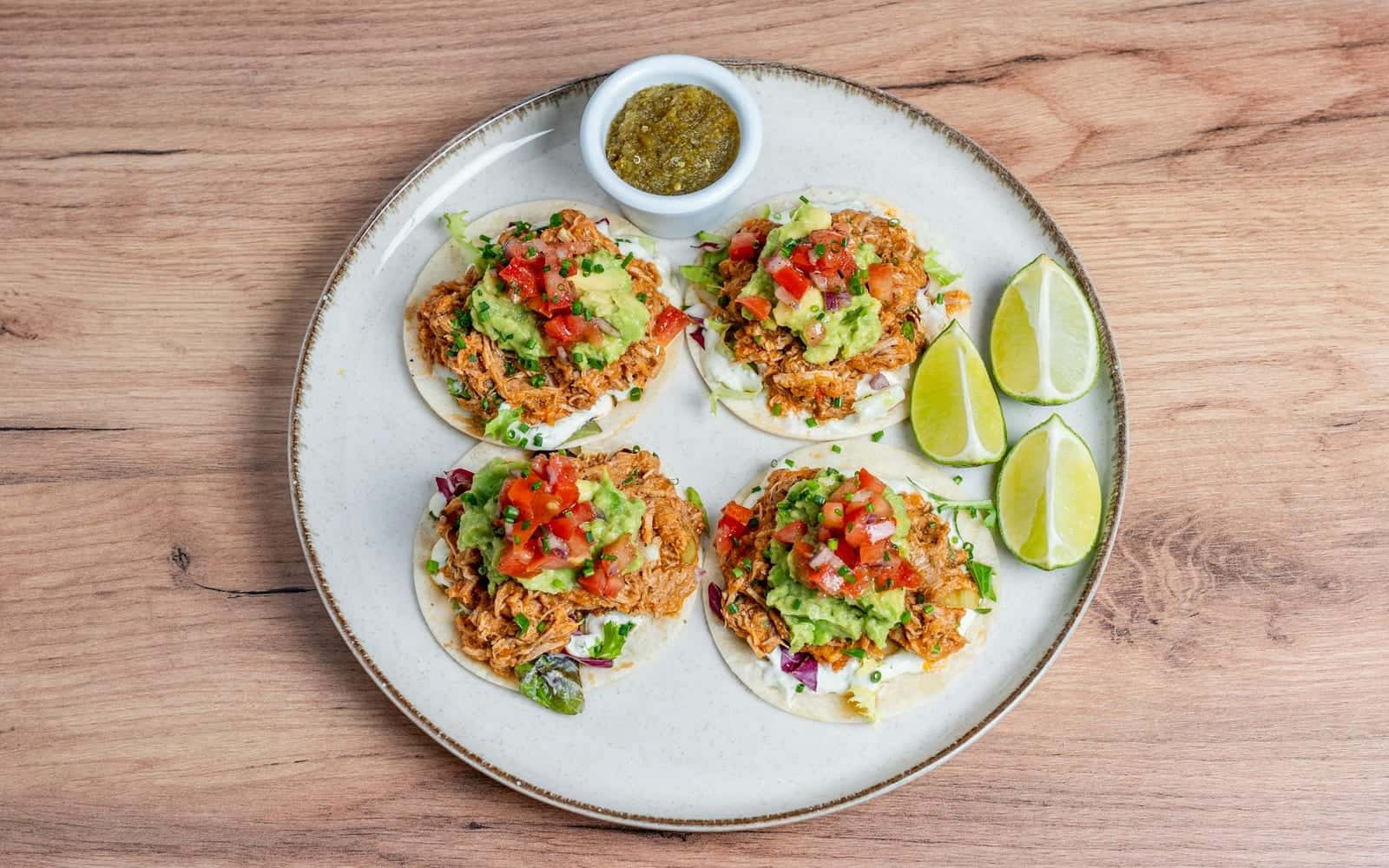 Dump-and-go salsa chicken-style tacos with tomato salsa, guacamole, and lime