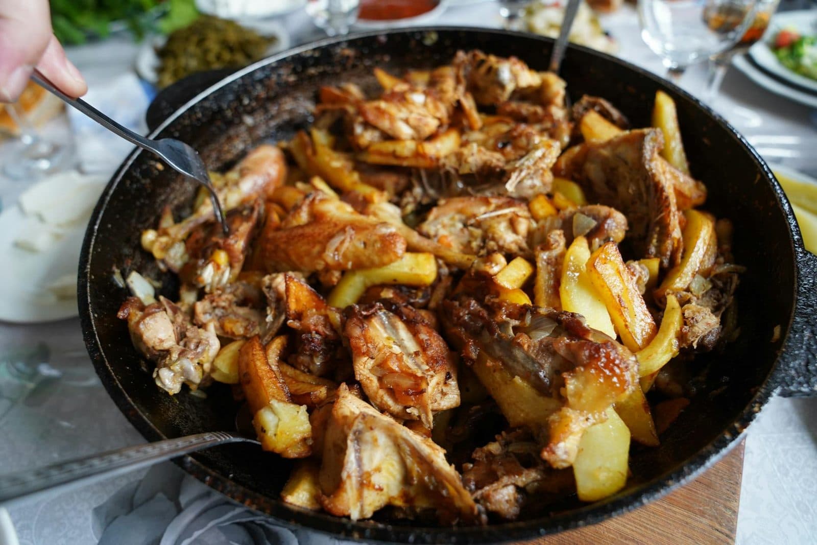 French mustard chicken and potatoes roasted together in a skillet with browned edges