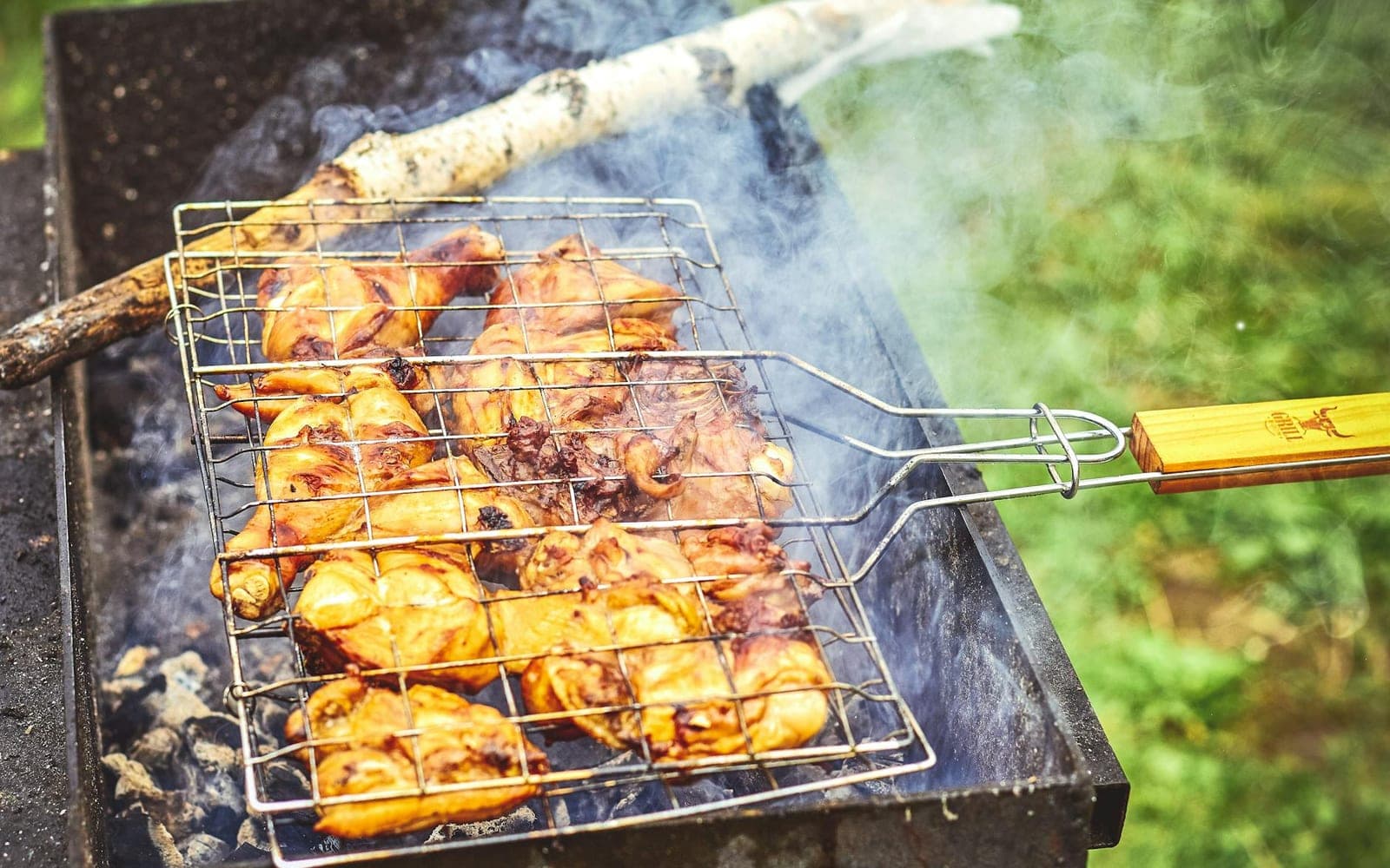 French mustard chicken thighs-style grilled chicken pieces on an outdoor barbecue
