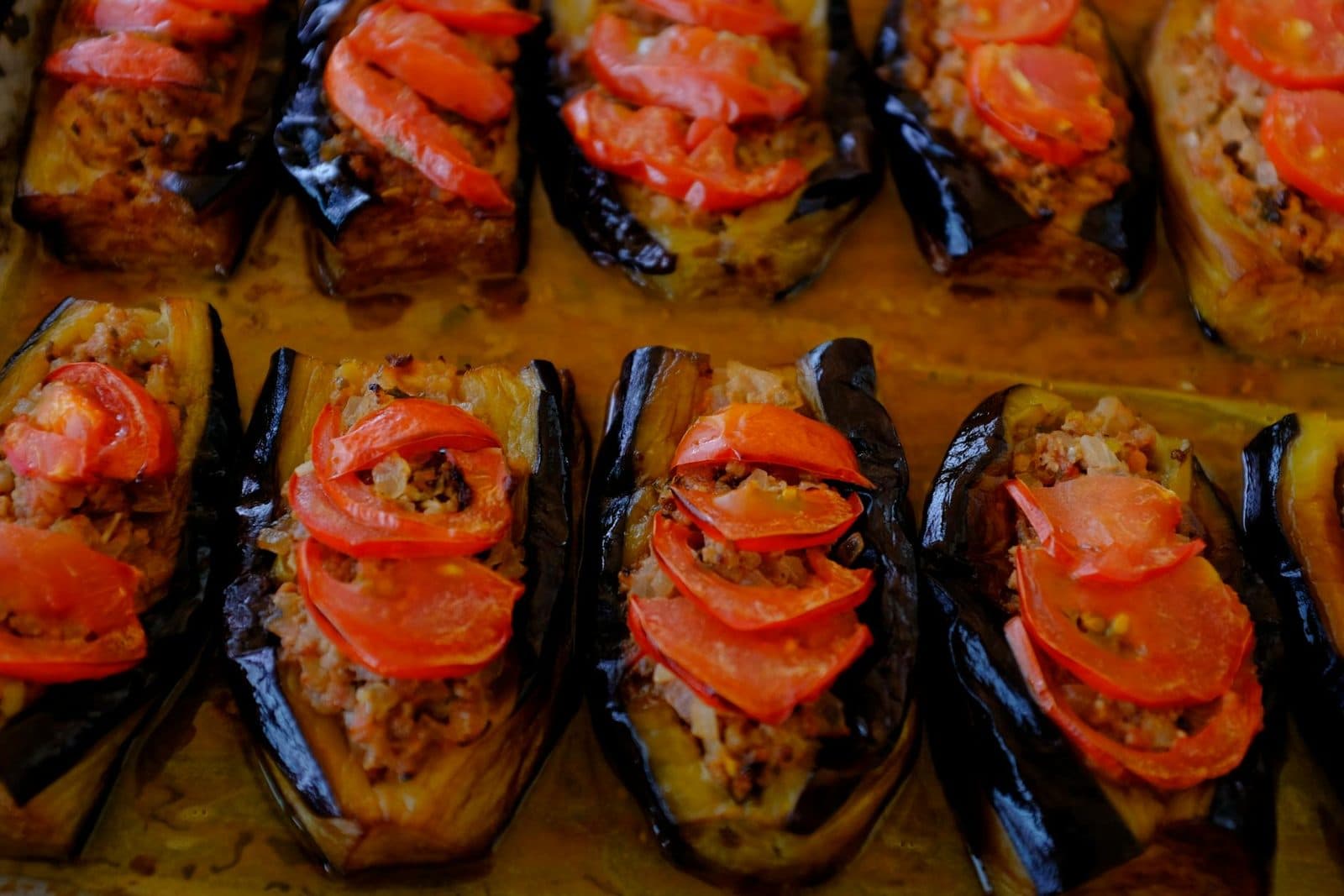 Imam bayildi eggplants stuffed with tomato and vegetables in a baking dish