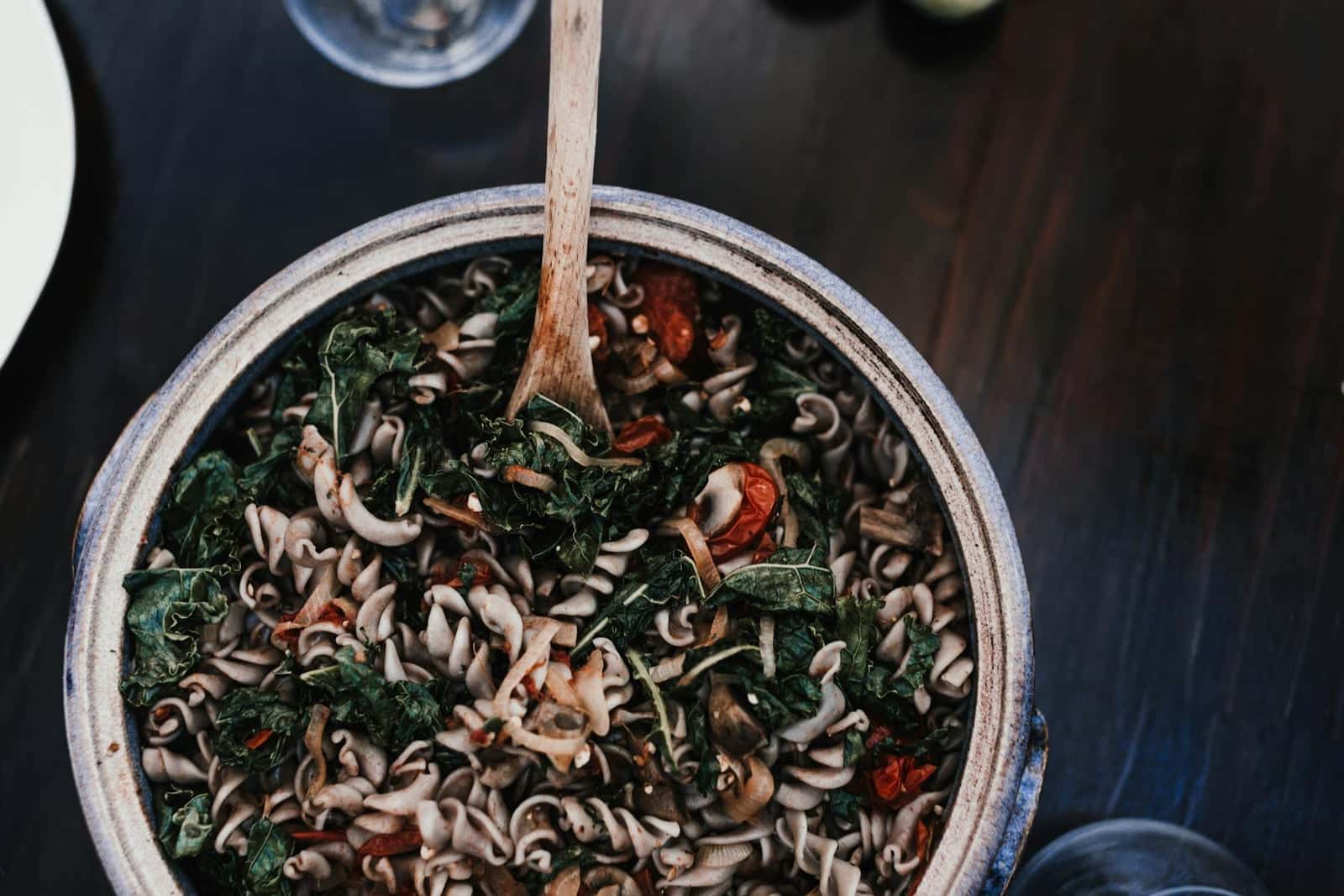 Italian kale pasta with beans, greens, and spiraled noodles in a deep pot