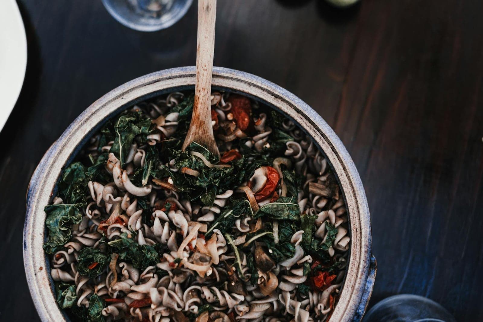 Italian kale pasta with beans, greens, and spiraled noodles in a deep pot