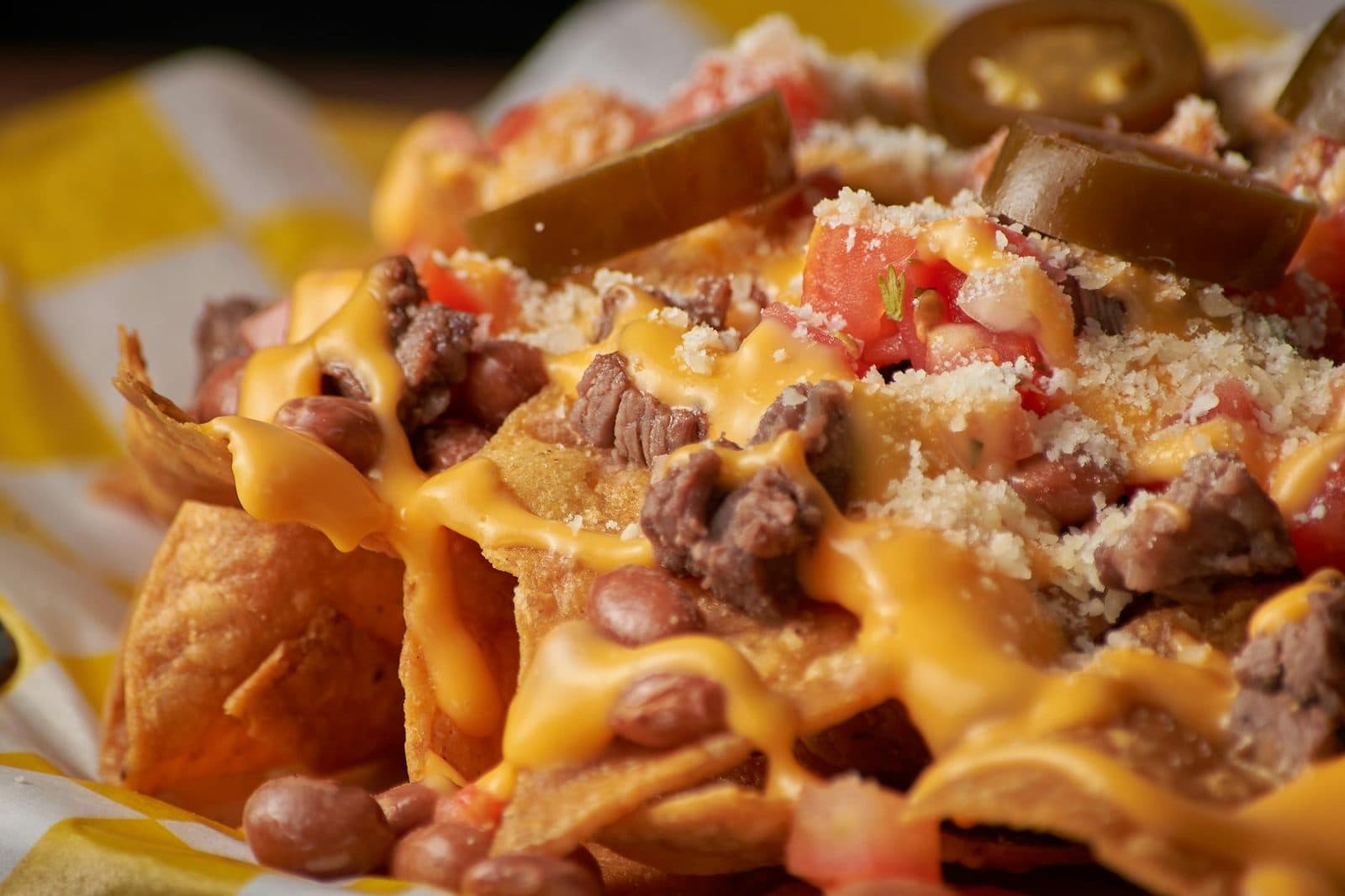 Loaded nachos supreme with melted cheese, beans, jalapenos, and toppings
