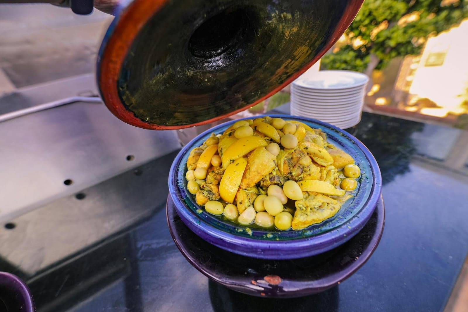 Moroccan chicken tagine with preserved lemons and olives in a blue tagine pot
