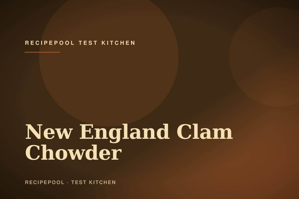 Bowl of creamy New England clam chowder topped with crackers and fresh chives