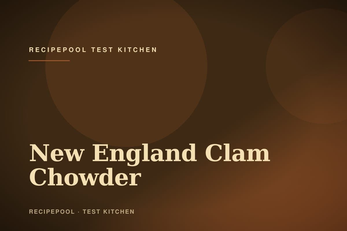 Bowl of creamy New England clam chowder topped with crackers and fresh chives