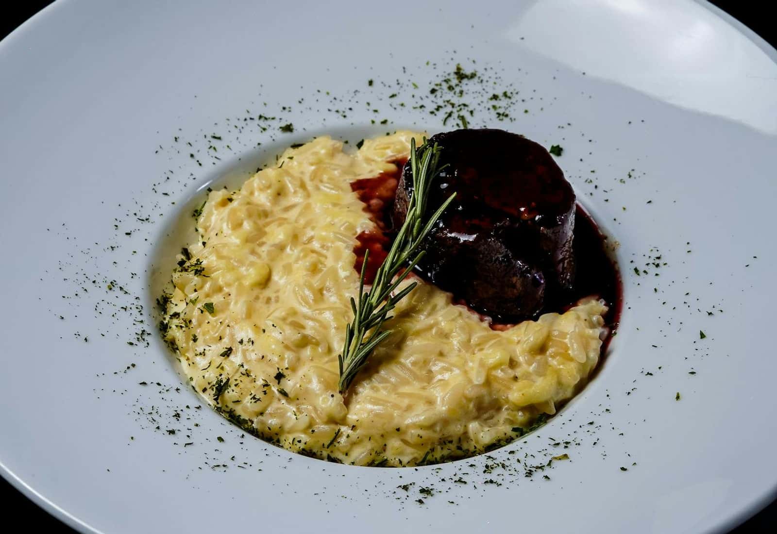 Osso buco alla Milanese-style braised meat served over creamy risotto with rosemary