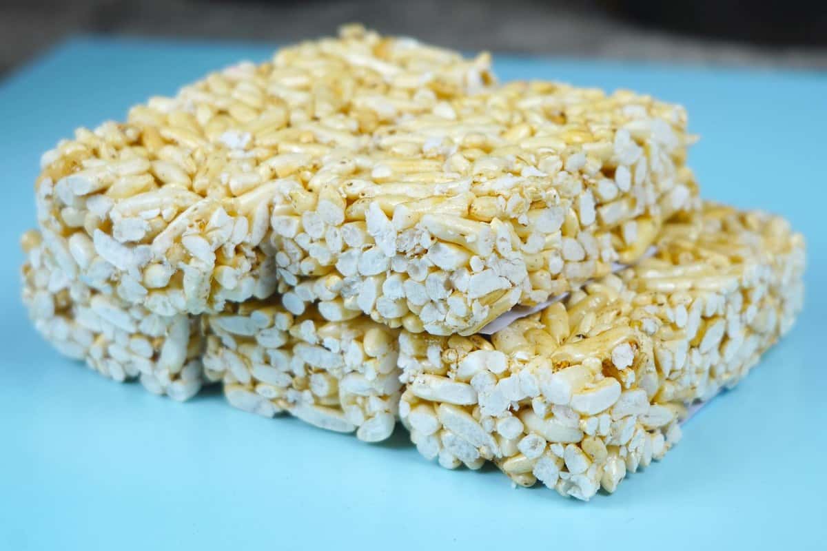 Stacked brown butter rice krispie bars on a blue surface