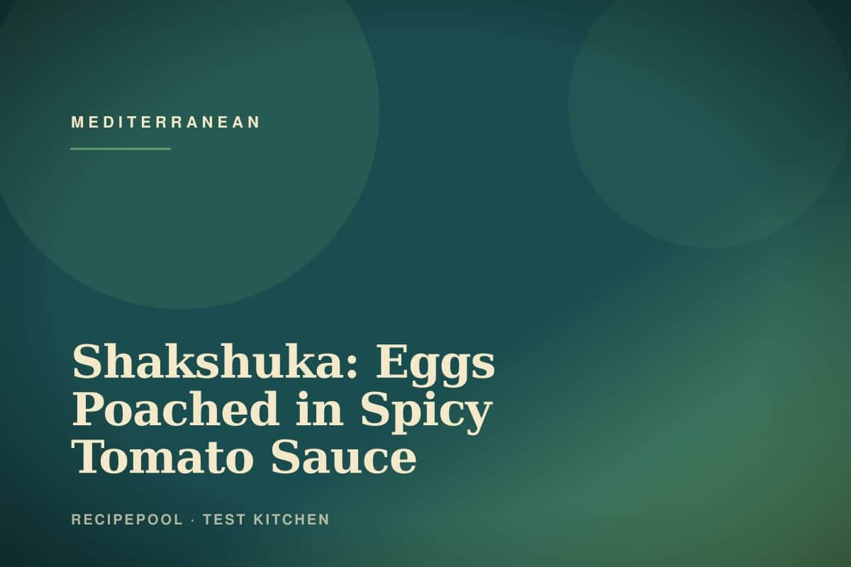 Skillet of shakshuka with eggs poached in spicy tomato sauce topped with fresh herbs