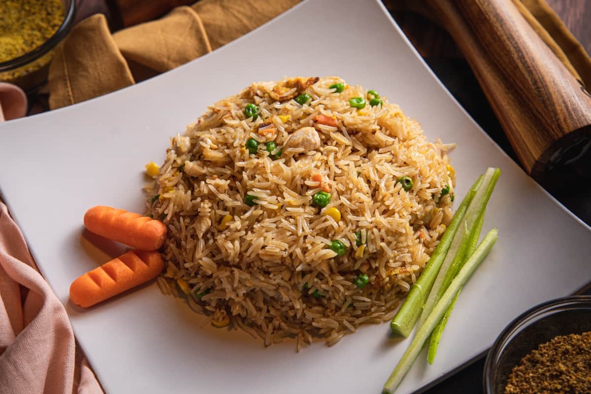 Close-up of shrimp fried rice served on a pedestal dish, ideal for food photography.