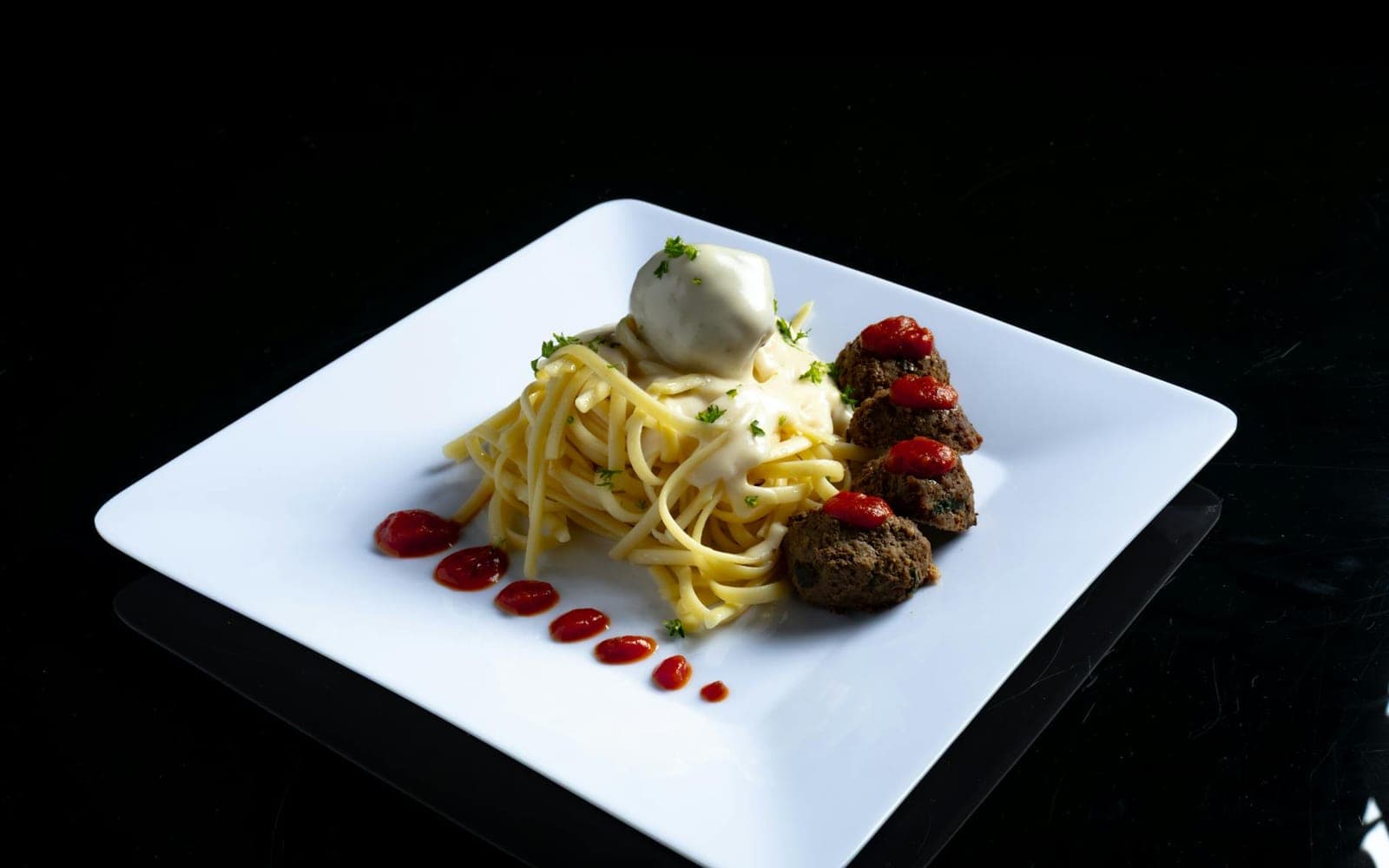 Classic spaghetti and meatballs on a white plate with pasta, sauce, and meatballs