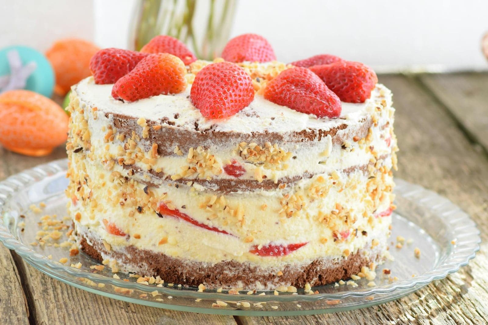 Strawberry layer cake with cream, fresh strawberries, and visible cake layers