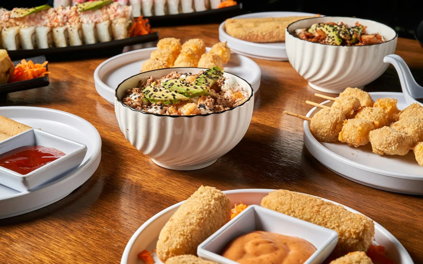 Veggie sushi bowls and sushi rolls with rice, vegetables, and colorful garnishes