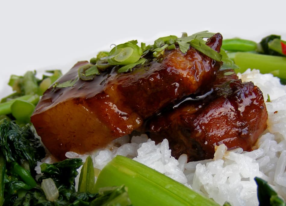 Glossy red braised pork belly cubes in a dark caramel sauce